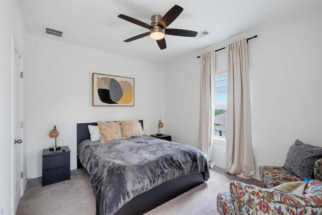 1205 Shady Fox Way, Arlington, TX 76005 Spacious room featuring neutral paint, carpeted flooring, a ceiling fan, and a window with light-filtering drapes