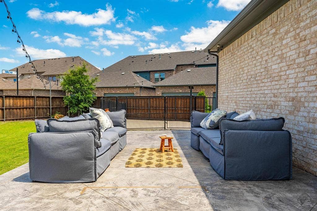 1205 Shady Fox Way, Arlington, TX 76005 Stamped concrete patio with a light brick exterior and dark gutters