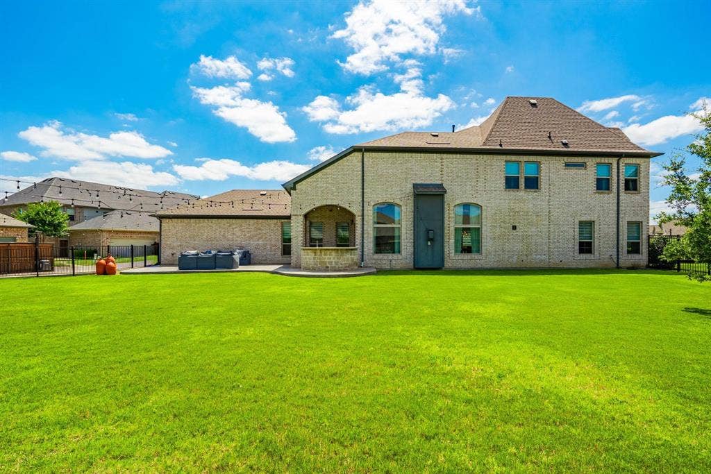1205 Shady Fox Way, Arlington, TX 76005 Expansive green lawn with a two-story brick exterior home