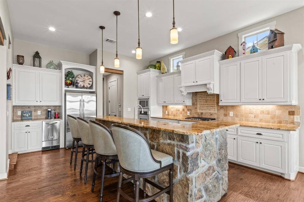 229 N Beverly Drive, Malakoff, TX 75148 Ample storage and bar seating at the stone accented island.