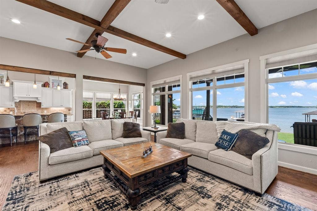 229 N Beverly Drive, Malakoff, TX 75148 Hand-scraped wood floors, wood beams, stone accents add to the charm. New windows installed in 2024 showcasing the open-water views.