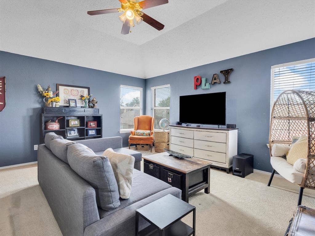 6004 Crestmill Lane, Sachse, TX 75048 Spacious room featuring a vaulted ceiling and a ceiling fan with integrated lighting