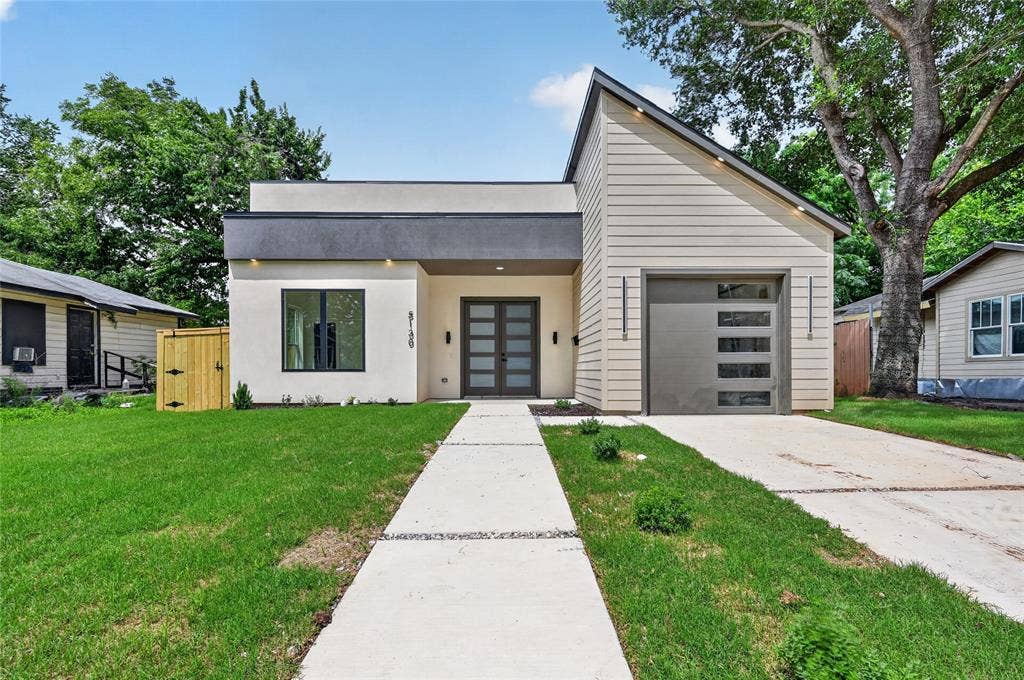 5130 Echo Avenue, Dallas, TX 75215 Contemporary exterior featuring a flat roofline and a sharply angled gable roof, a modern garage door with rectangular window inserts, and a dual-panel glass entry door