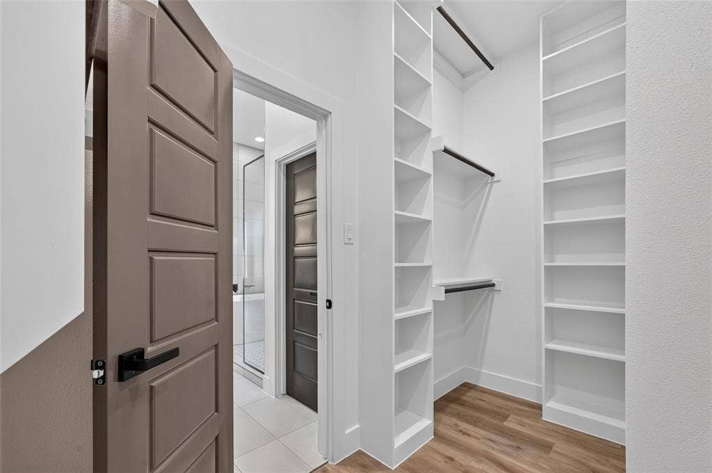 5130 Echo Avenue, Dallas, TX 75215 Custom closet system featuring extensive shelving and hanging rods
