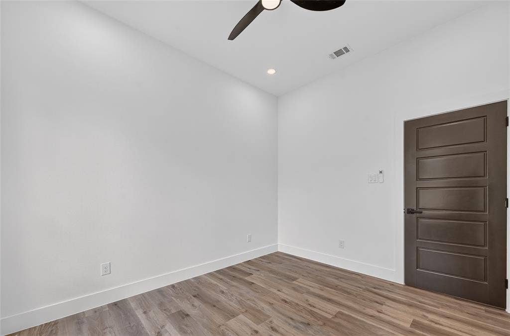 5130 Echo Avenue, Dallas, TX 75215 Interior room featuring wood-finish flooring, white walls, and white baseboards