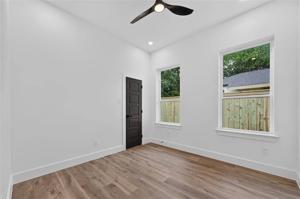 5130 Echo Avenue, Dallas, TX 75215 Room featuring light wood-finish flooring, white baseboards, and bright white walls