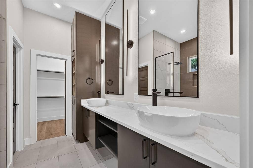 5130 Echo Avenue, Dallas, TX 75215 Double vanity with vessel sinks, quartz countertops, dark wood-finish cabinetry, and contemporary lighting