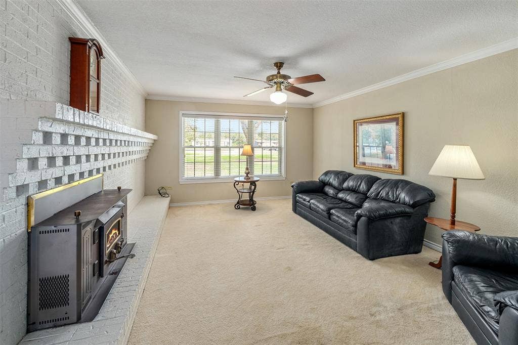 11608 State Highway 19 N, Athens, TX 75752 Living room with large windows and wood burning stove