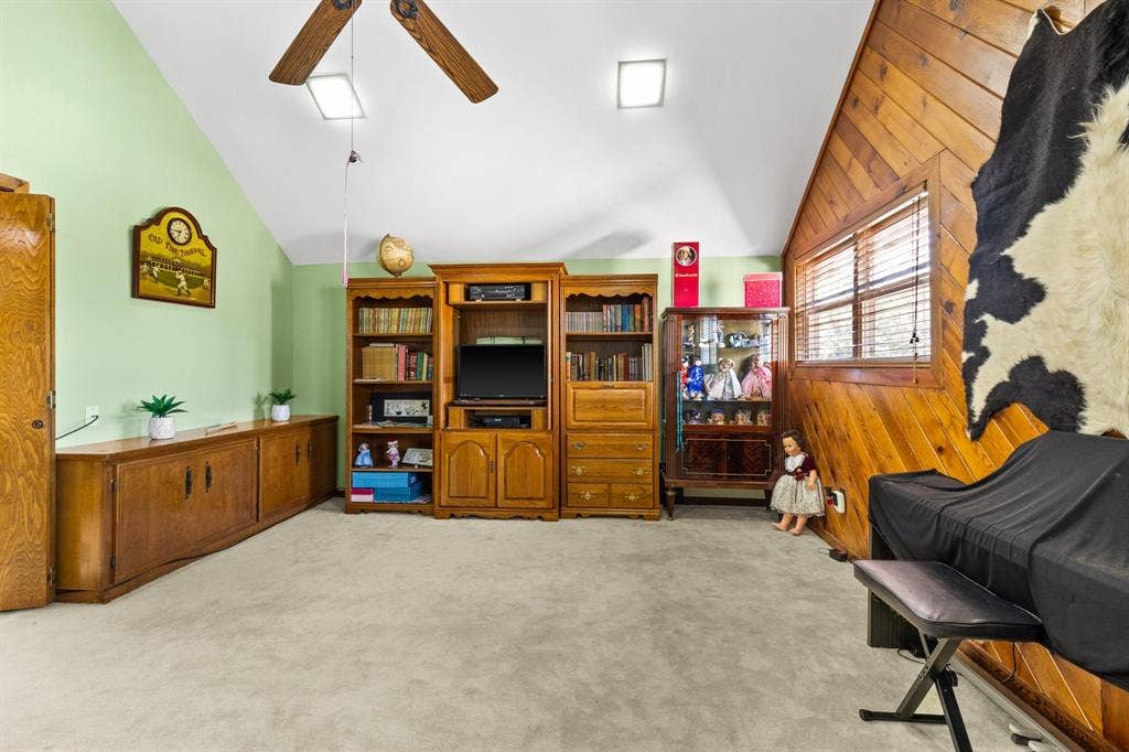 5602 Fountainbridge Ln, Houston, TX 77069 Game Rm with vaulted ceiling, cedar-paneled wall,ceiling fan and natural light.