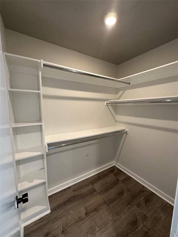 5018 San Jacinto Street, #107, Dallas, TX 75206 Walk-in closet featuring wood-finish flooring, recessed lighting, white built-in shelving, white baseboards, and chrome hanging rods