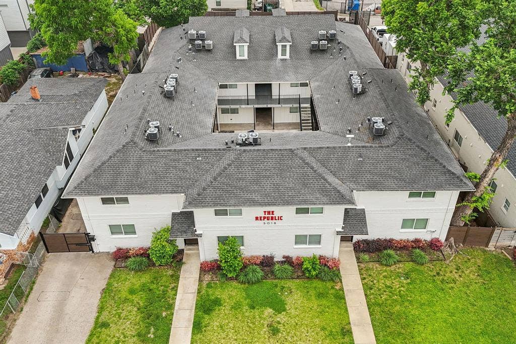 5018 San Jacinto Street, #107, Dallas, TX 75206 U-shaped building with a dark shingle roof, multiple dormer windows, and a central courtyard