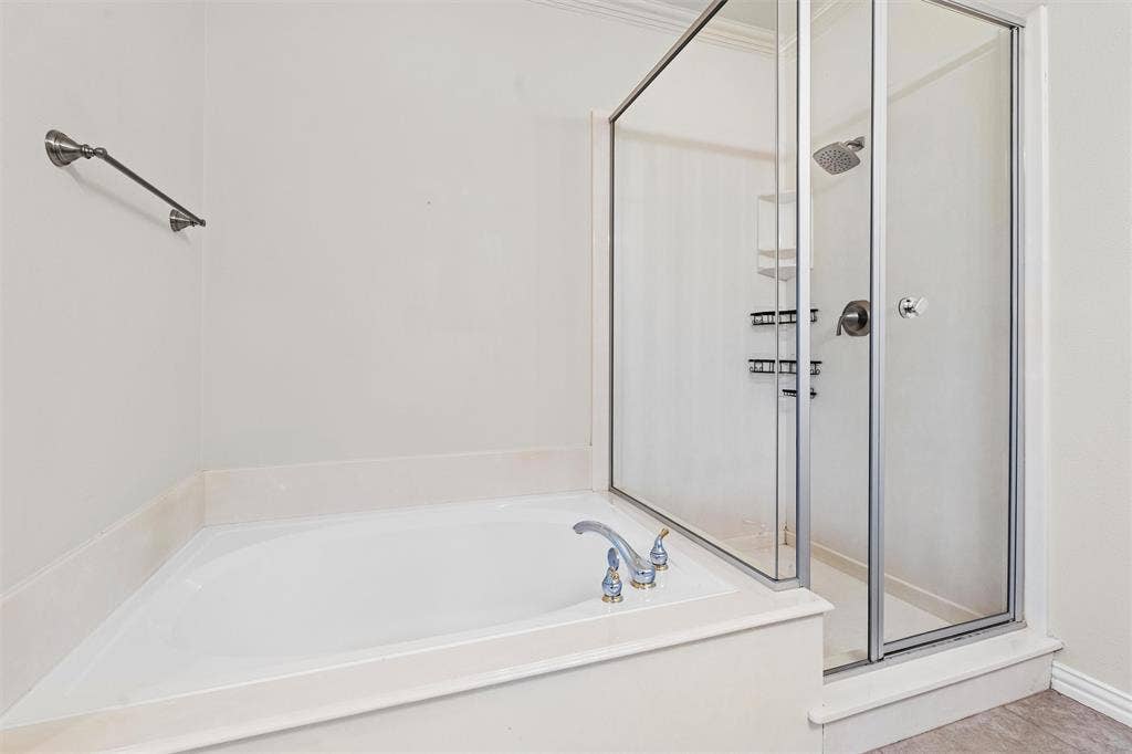 4424 Honfleur Court, Irving, TX 75038 The primary bath has a large soaking tub and a separate shower.