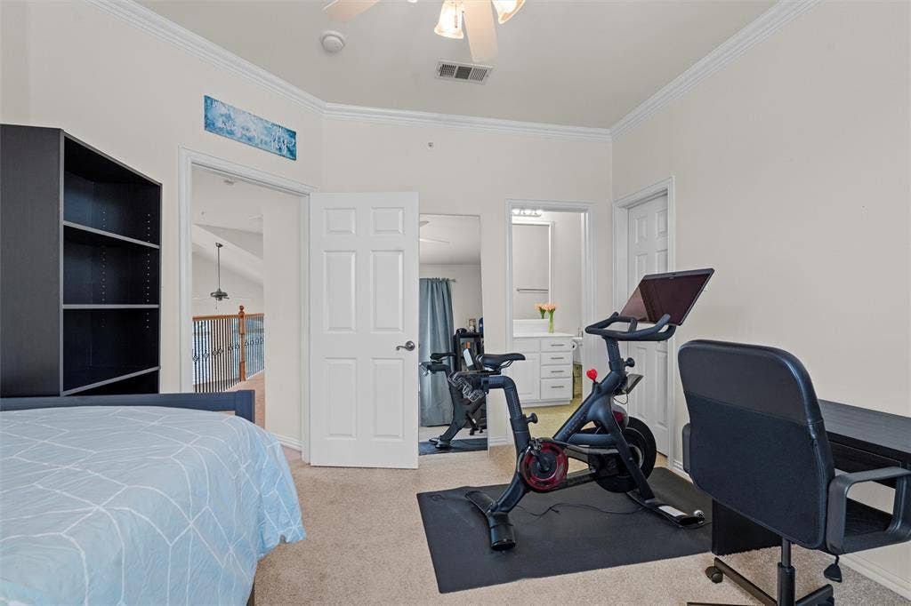 4424 Honfleur Court, Irving, TX 75038 Bedroom with light colored carpet, crown molding, and a ceiling fan