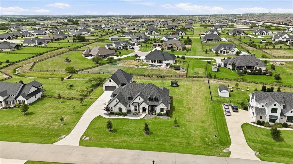 Expansive residential development featuring numerous single-family homes on large, green lots