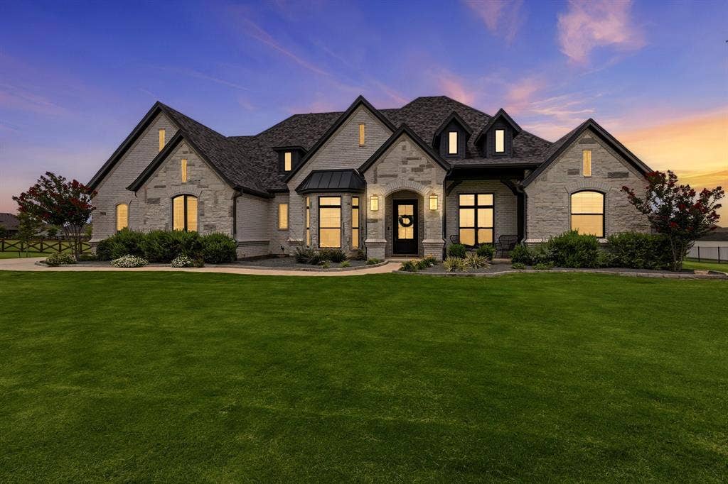 Main Home - Stone and stucco exterior with dark trim accents