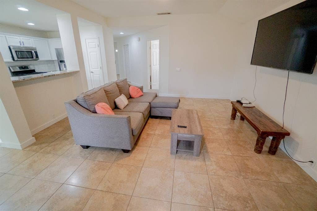 203 Grassy Creek Drive, Wylie, TX 75098 Bright living area featuring neutral-toned tile flooring throughout. 203 Grassy Creek Dr, Wylie, TX 75098