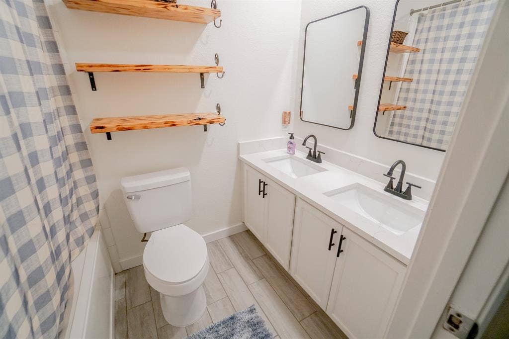 203 Grassy Creek Drive, Wylie, TX 75098 Double vanity with white cabinetry, matte black hardware, and integrated rectangular sinks