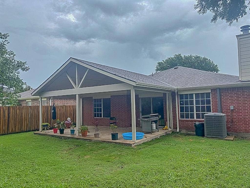 203 Grassy Creek Drive, Wylie, TX 75098 Expansive backyard featuring a covered patio, brick exterior, and a new privacy fence