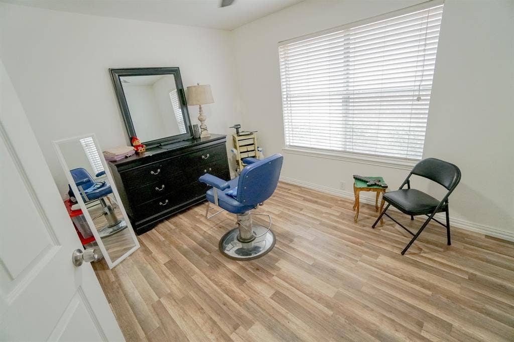 203 Grassy Creek Drive, Wylie, TX 75098 Bright room featuring wood-finish flooring, white walls, and a large window with blinds