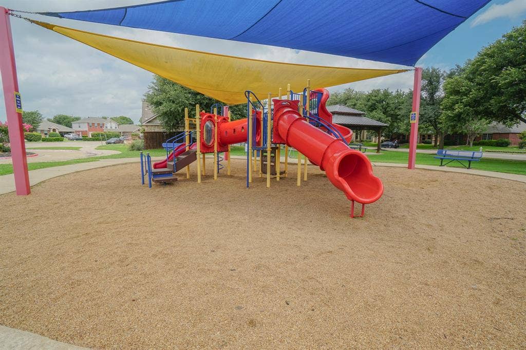 203 Grassy Creek Drive, Wylie, TX 75098 Community playground featuring a red and blue play structure with slides and tunnels