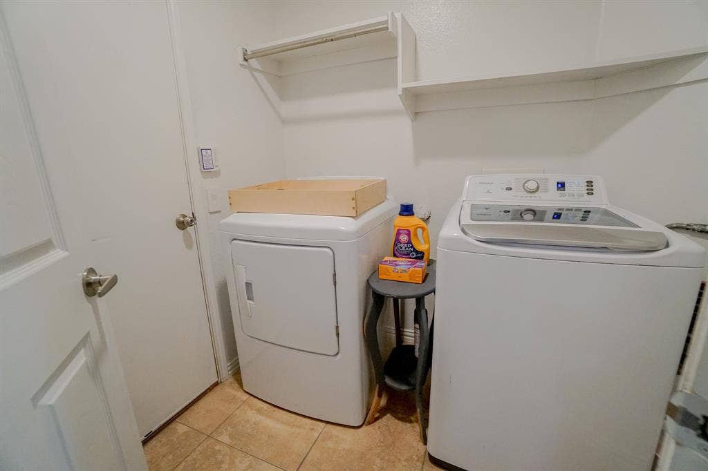 203 Grassy Creek Drive, Wylie, TX 75098 Dedicated laundry area featuring tile flooring, white walls, and built-in shelving
