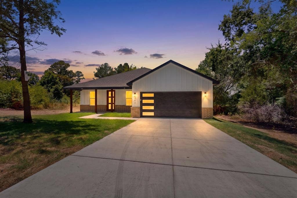 343 SCHOONER Road, Gun Barrel City, TX 75156 Contemporary single-story residence with a dark metal roof and board and batten siding