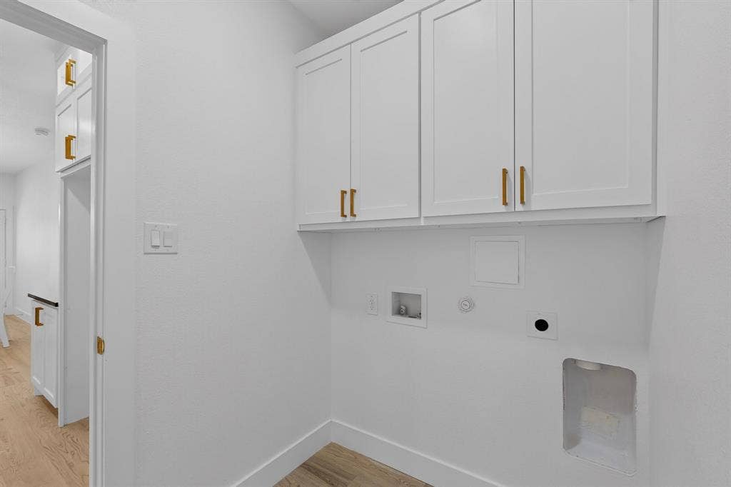 343 SCHOONER Road, Gun Barrel City, TX 75156 Dedicated laundry area featuring white shaker-style cabinetry with gold-tone hardware, providing ample storage