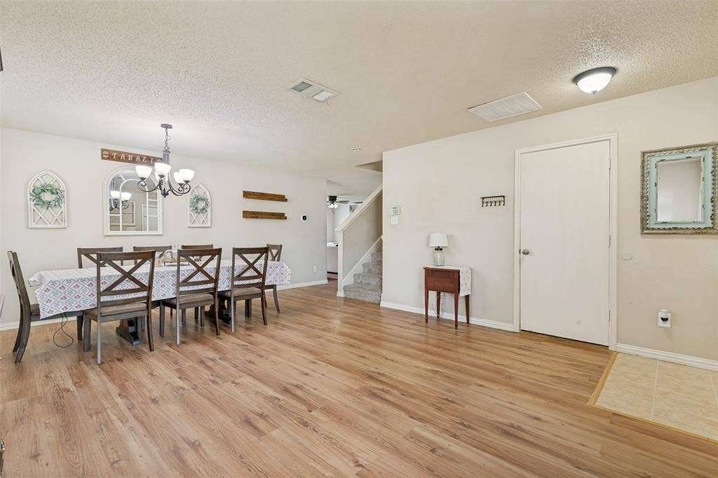 605 Rock Brook Drive, Forney, TX 75126 Spacious dining area featuring wood-finish flooring, a contemporary chandelier, and ample wall space