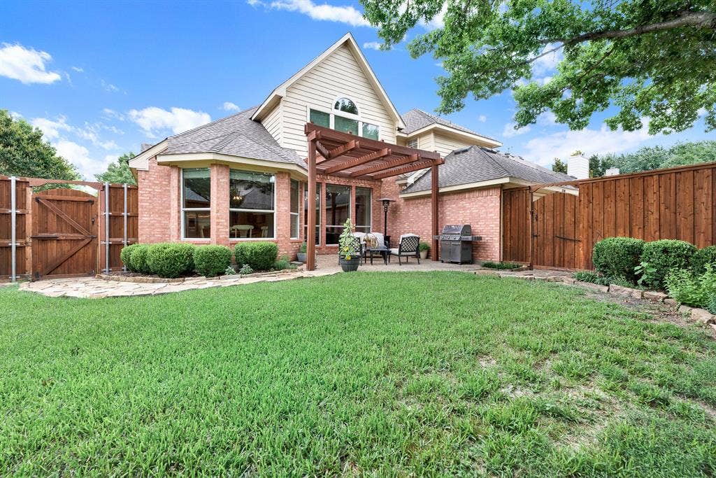 3708 Stockport Drive, Plano, TX 75025 The classic brick elevation peaks with a wall of large windows and an arched accent window that mirrors the open blue sky. Picture hosting a lively summer barbecue where guests easily mingle between the open-air patio and the indoor kitchen.