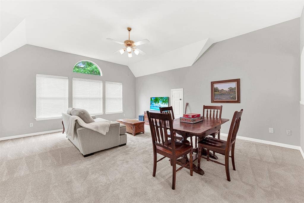 3708 Stockport Drive, Plano, TX 75025 Dramatic vaulted ceiling angles draw the eye upward, amplifying the room's sense of openness. Imagine spending a rainy Saturday afternoon completely relaxed here while natural light fills the space through the arched window.