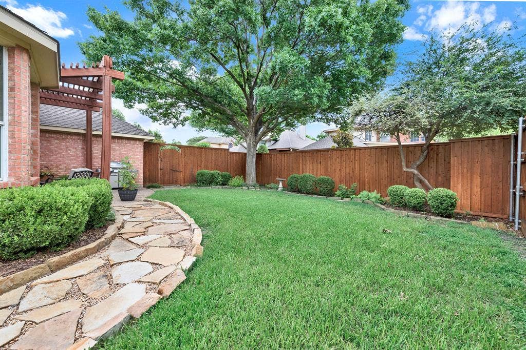3708 Stockport Drive, Plano, TX 75025 A winding flagstone path curves gracefully along the lawn, leading the eye beneath the canopy of a sprawling shade tree. Take a peaceful morning stroll with your coffee, appreciating the crisp air and the neatly manicured perimeter landscaping.