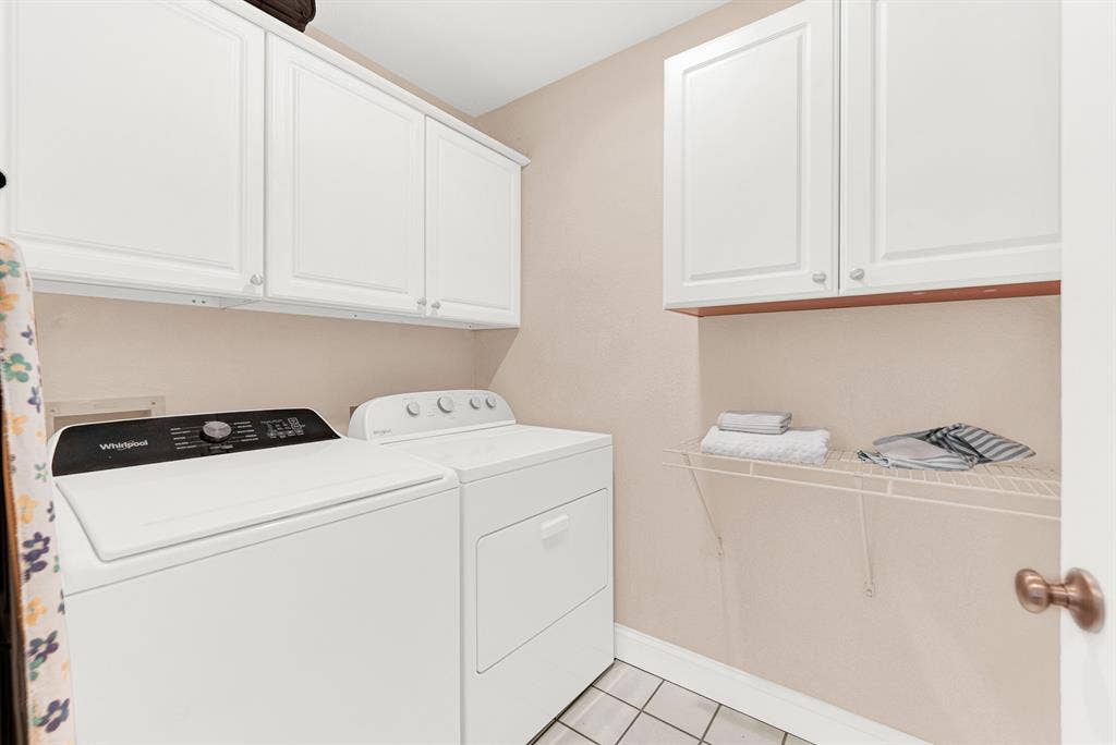 3708 Stockport Drive, Plano, TX 75025 Crisp white cabinetry lines the upper walls, maximizing the efficiency of this brightly illuminated service space. You can easily transition from the garage after a busy day, dropping off items right onto the durable tiled flooring.