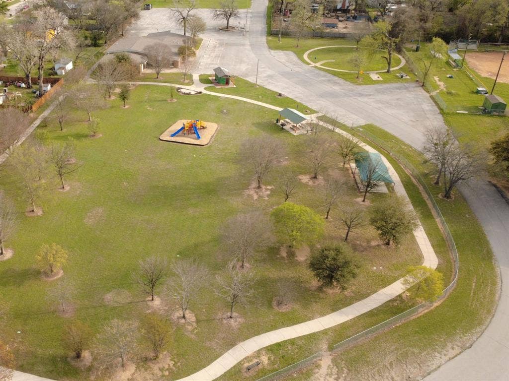 1912 Bernice Street, #B, Haltom City, TX 76117 Expansive green space featuring a playground structure, multiple covered picnic areas, a winding paved pathway, and mature trees