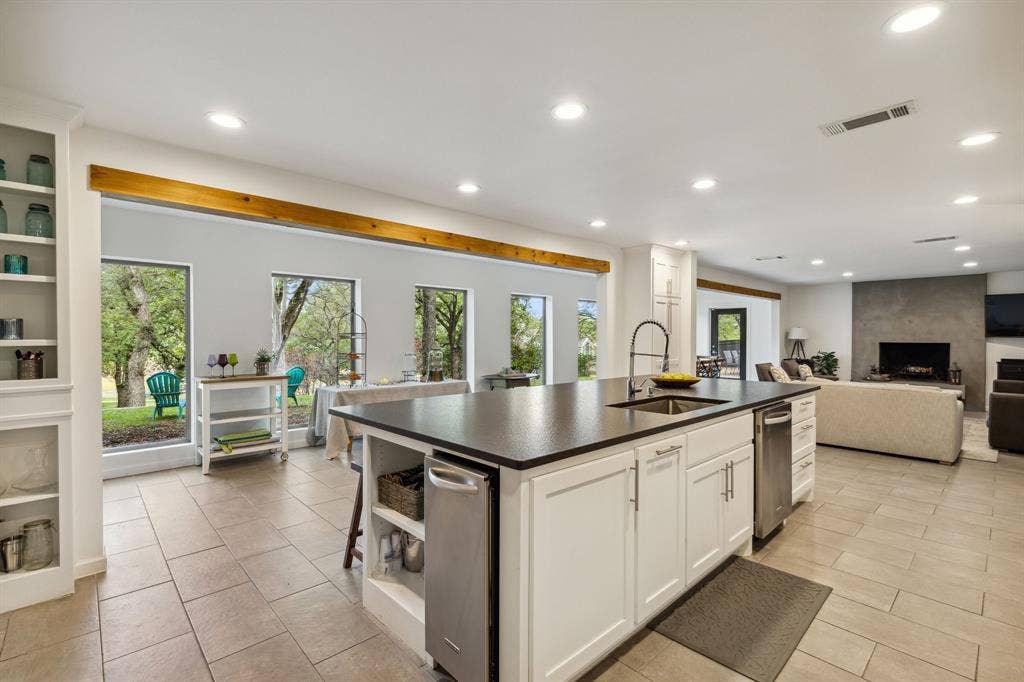 7342 Briar Road, Azle, TX 76020 Chef's kitchen with open layout features a very large eat-in island, custom cabinets, and a wealth of natural light