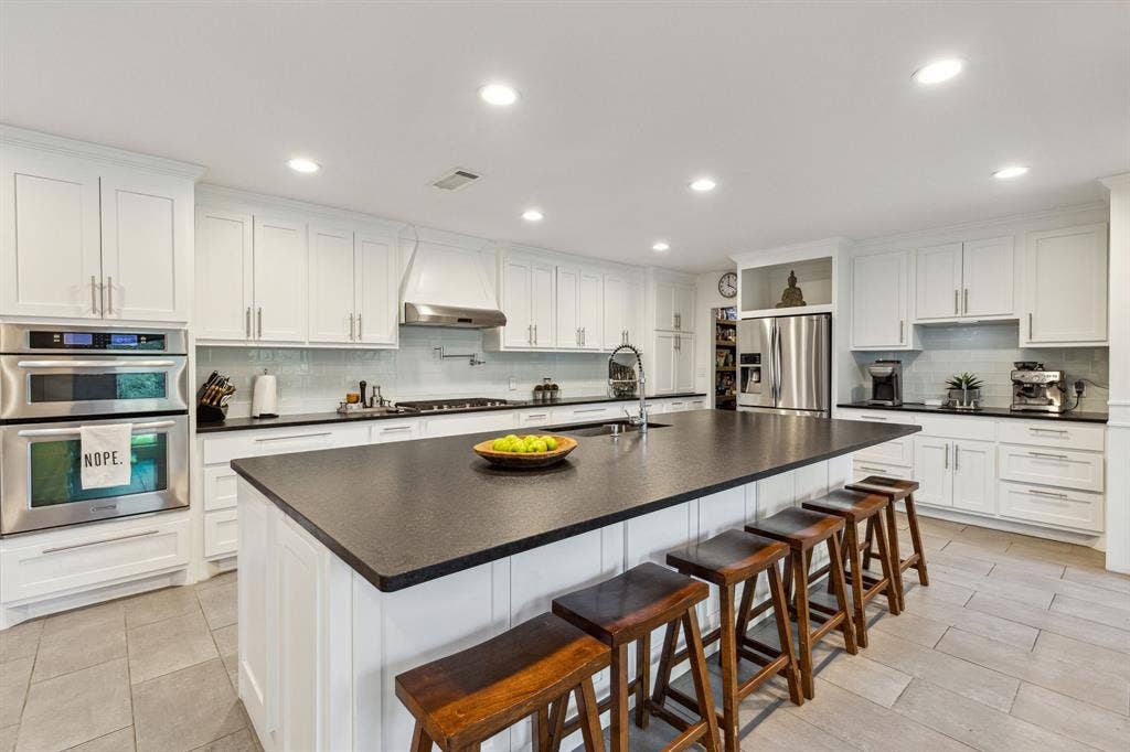 7342 Briar Road, Azle, TX 76020 Kitchen featuring custom cabinets with plenty of storage and sitting space for entertainment