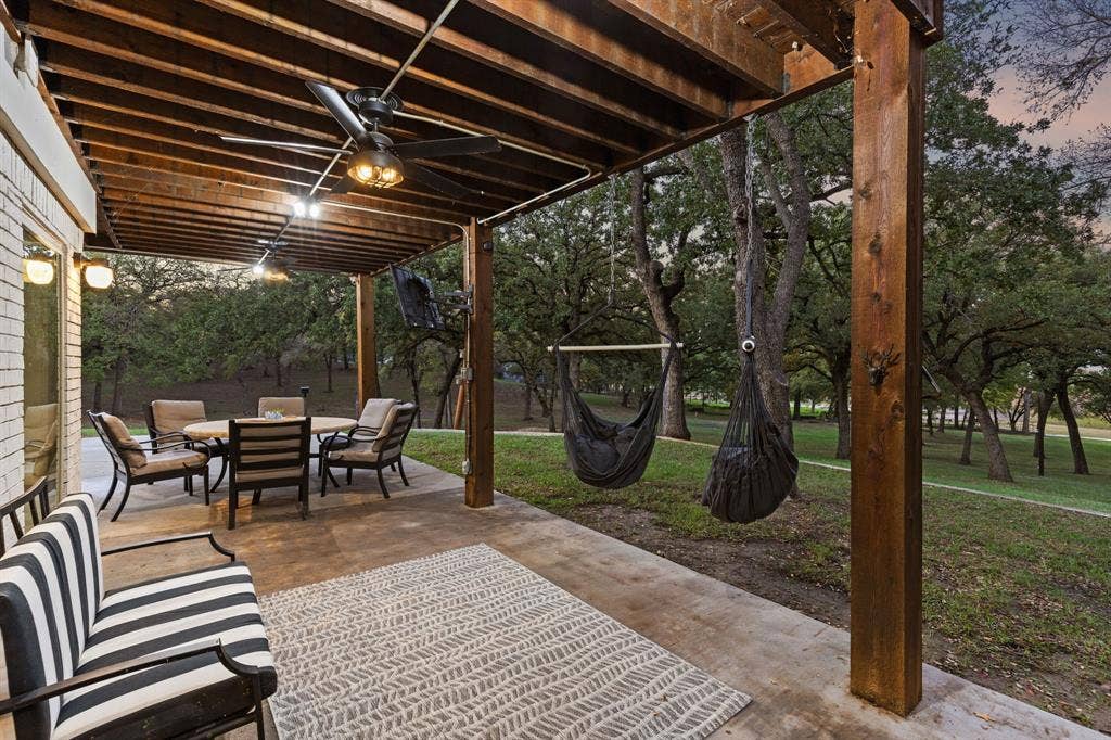 7342 Briar Road, Azle, TX 76020 Patio terrace at dusk with ceiling fan and a yard