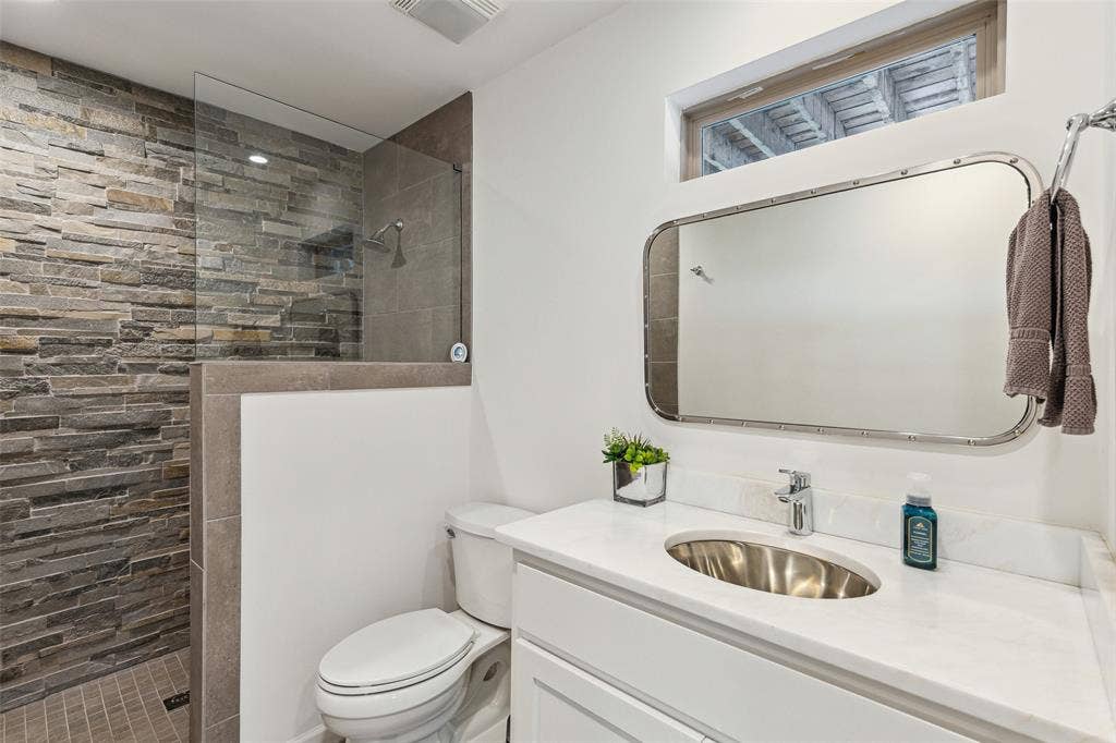 7342 Briar Road, Azle, TX 76020 Bathroom with tiled shower, toilet, and large vanity