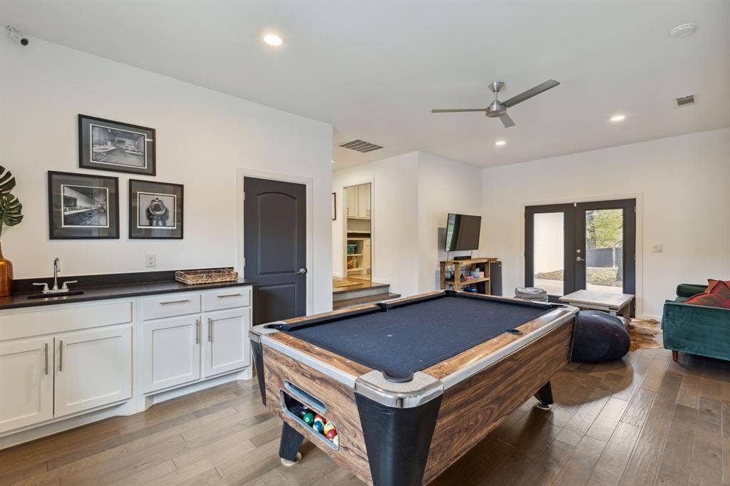 7342 Briar Road, Azle, TX 76020 Game room features a wet bar, a celing fan and double doors that open into the courtyard