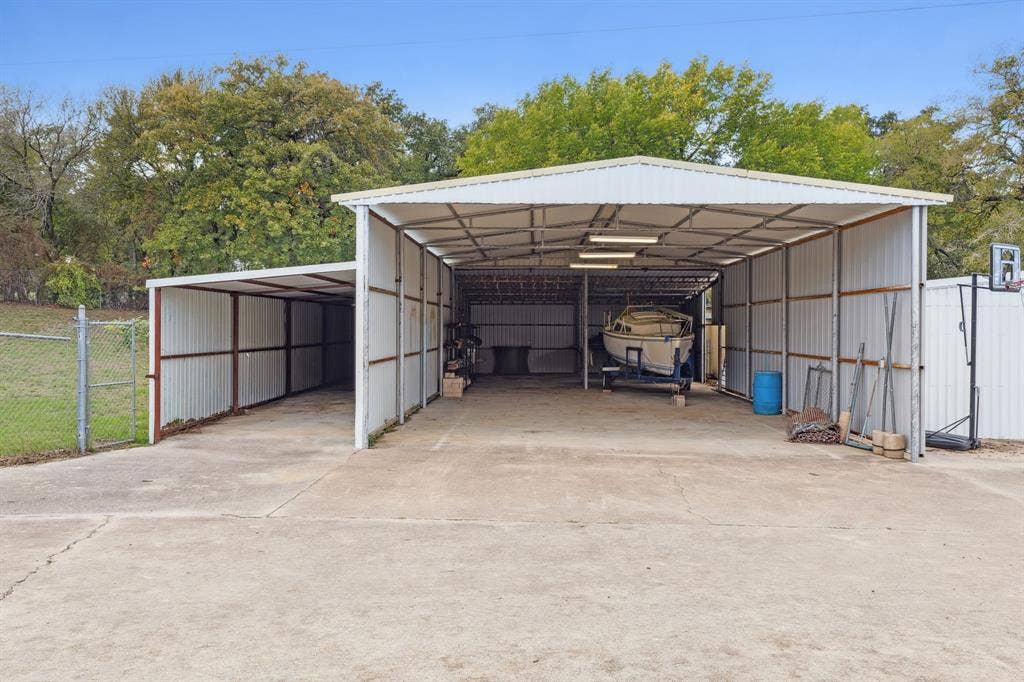 7342 Briar Road, Azle, TX 76020 View of parking / parking lot featuring a tall carport perfect to park RV and/or boat