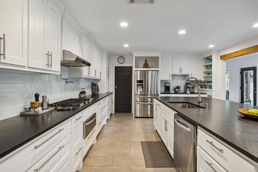 7342 Briar Road, Azle, TX 76020 Kitchen featuring appliances with stainless steel finishes, white cabinetry, and leathered granite countertops
