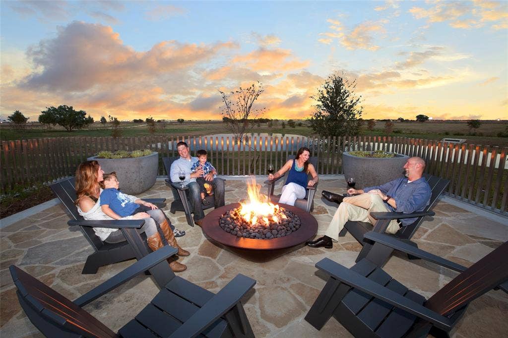 3960 Medio Creek Drive, Prosper, TX 75078 Expansive outdoor patio featuring flagstone paving, a built-in circular fire pit, and durable fencing