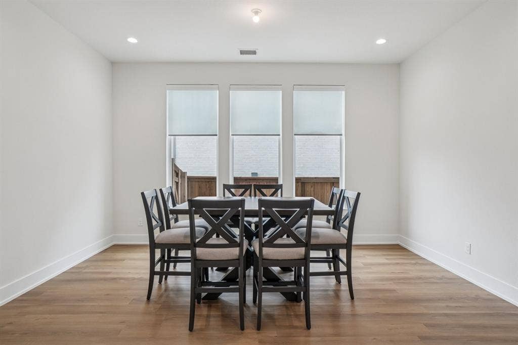 3960 Medio Creek Drive, Prosper, TX 75078 Spacious room featuring wood-finish flooring, crisp white walls, and white baseboards