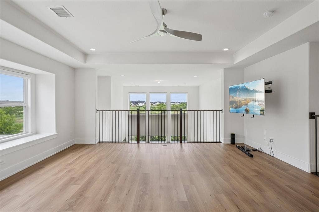 3960 Medio Creek Drive, Prosper, TX 75078 Spacious open loft area featuring wood-finish flooring, recessed lighting, and a contemporary ceiling fan