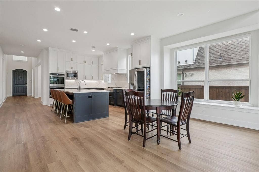 3960 Medio Creek Drive, Prosper, TX 75078 Open-concept kitchen and dining area featuring light wood-finish flooring