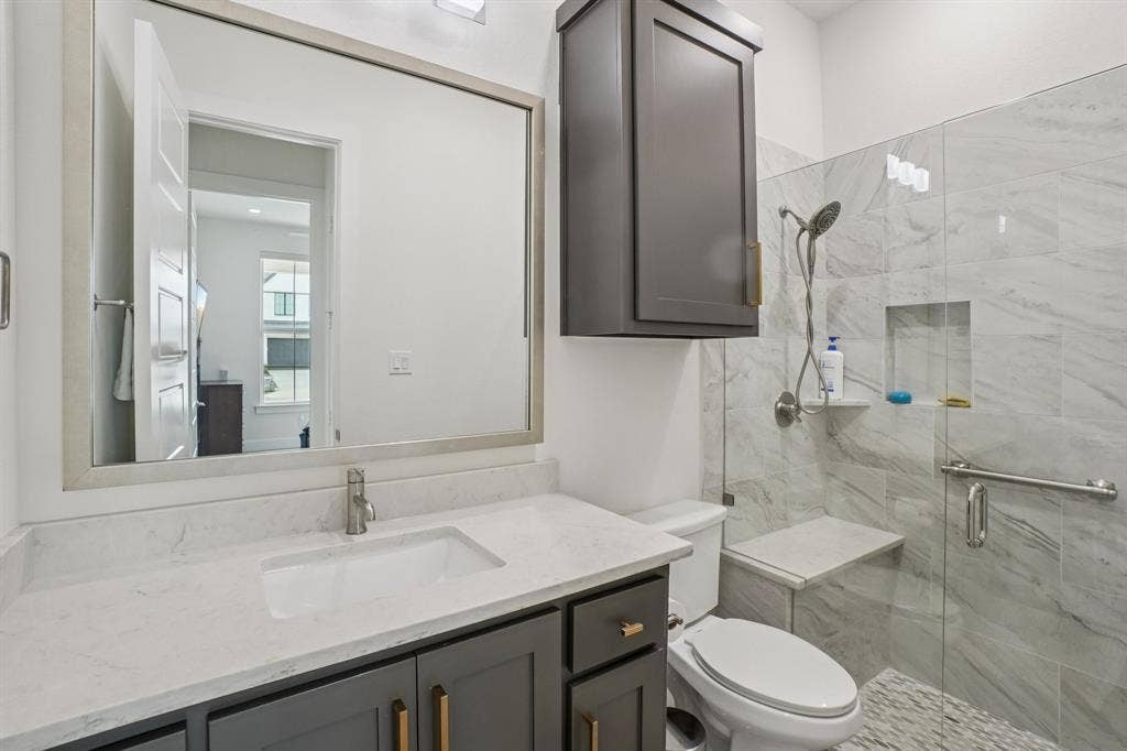 3960 Medio Creek Drive, Prosper, TX 75078 Bathroom featuring a gray vanity with a white countertop, a rectangular sink, and a framed mirror