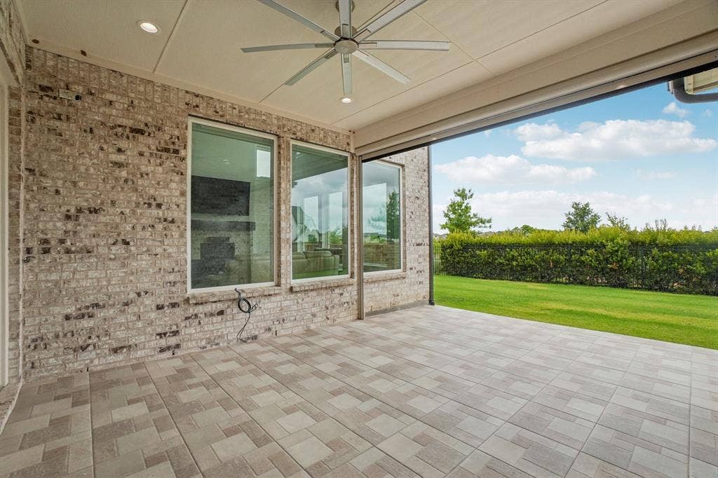 3960 Medio Creek Drive, Prosper, TX 75078 Expansive covered patio featuring brick exterior walls, recessed lighting, and a ceiling fan
