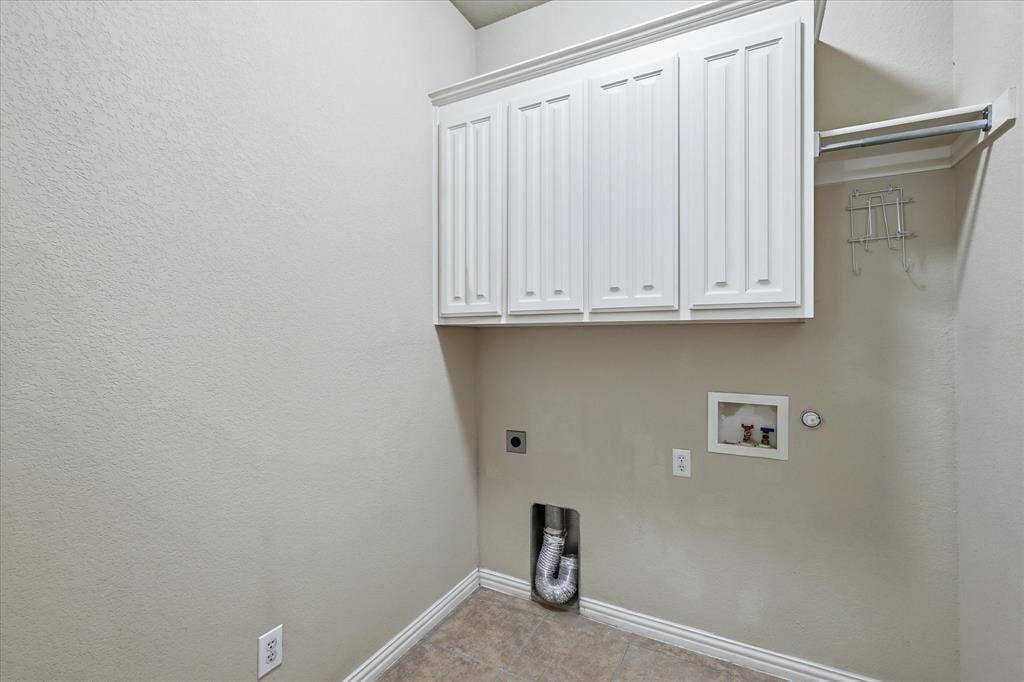 1905 Fountain Meadows Drive, Euless, TX 76039 The Laundry Room features built-in cabinetry and a clothing rod with shelf.