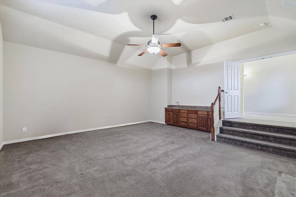 1905 Fountain Meadows Drive, Euless, TX 76039 Generous sized step down media room provides the perfect space for movie nights. Also featured is a wet bar with cabinet storage.