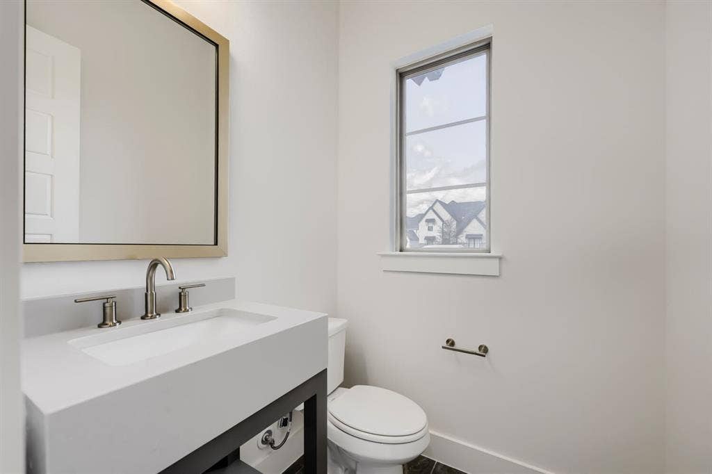 1317 Naples Court, Keller, TX 76248 Integrated rectangular sink with brushed nickel faucet, framed mirror, and vertical window