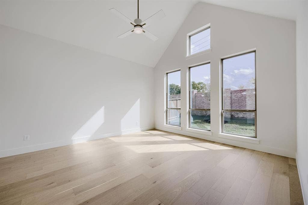 1317 Naples Court, Keller, TX 76248 Vaulted ceiling, contemporary ceiling fan, light wood-finish flooring, and multiple windows